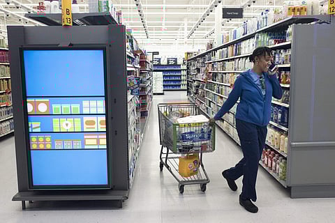 A customer pulls her shopping cart past an information kiosk at a Walmart Neighborhood Market, Wednesday, April 24, 2019, in Levittown, N.Y. (Photo | AP)