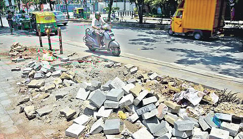 Broken tiles of a footpath near Vega City Mall in JP Nagar. Several foootpaths in the city, which are meant for pedestrians, are  in bad shape. Most of them have either been encroached by shops and vendors or have uneven tiles | sHRIRAM B N