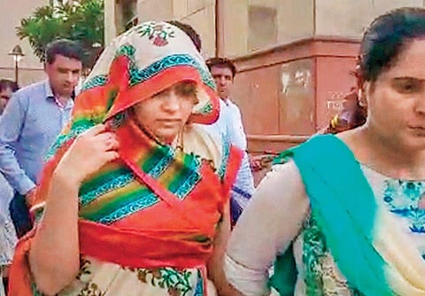 Apoorva Tiwari being escorted by the police. (Photo| PTI)