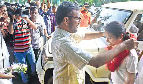M B Rajesh MP receiving P U Chithra when she reached Palakkad on Friday