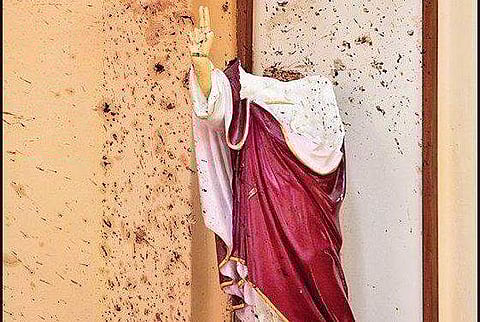 A statue is shown with a broken head as a result of an explosion during the Sri Lanka bombings