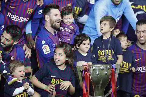 Barcelona captain Lionel Messi with his children pose with the La Liga trophy at the Camp Nou stadium (Photo | AP)