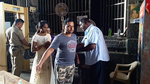 The police are using hand-held metal detector to scan the visitors and their baggage before allowing them to walk into the temple.