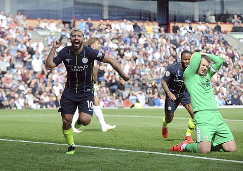 Manchester City's Sergio Aguero, left, celebrates after scoring his side's opening goal during the English Premier League soccer match between Burnley and Manchester City at Turf Moor in Burnley (Photo | AP)