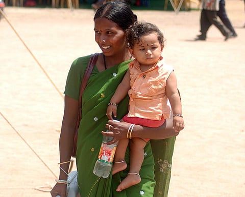 A poll official reporting for election duty along with her child (File Photo | EPS)