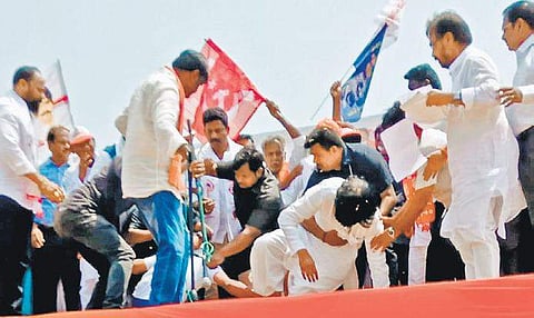Jana Sena chief Pawan Kalyan loses his balance as a follower tries to touch his feet at a public meeting in Vizianagaram town on Friday | Express Photo