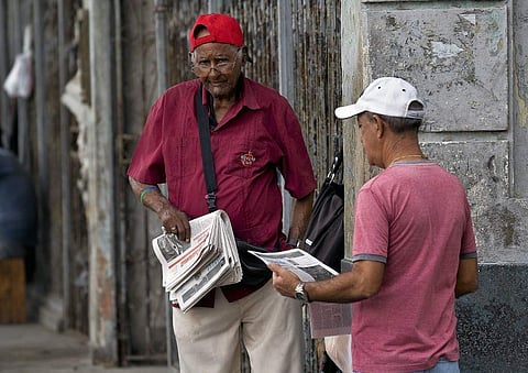 A vendor sells newspaper in a street of Havana. (Photo: AFP)