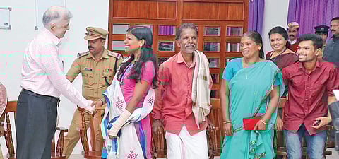 Governor P Sathasivam greets Sreedhanya Suresh, the first candidate from the Kurichya community in Wayanad to clear the civil services examination, at the Government Rest House in Kalpetta. Sreedhanya’s family members are also seen