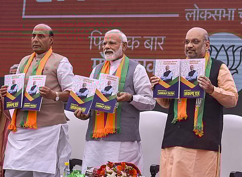 Prime Minister Narendra Modi BJP President Amit Shah and Union Home Minister Rajnath Singh release Bharatiya Janata Party's manifesto Sankalp Patra for Lok Sabha elections 2019 in New Delhi. (Photo | PTI)