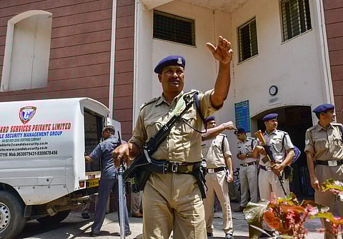 CRPF jawans guard as Income Tax officials recover cash after raids at the premises of lobbyist Ashwini Sharma in Bhopal. (Photo | PTI)
