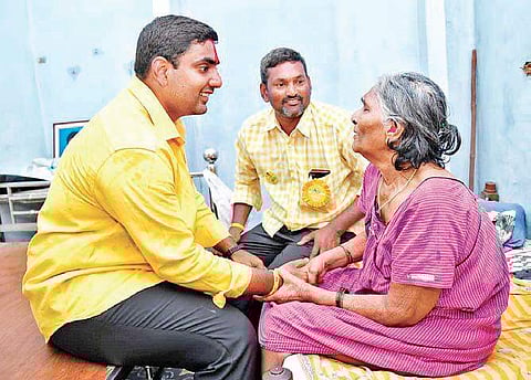 TDP’s Nara Lokesh interacts with an aged voter in Undavalli on Monday | P Ravindra Babu