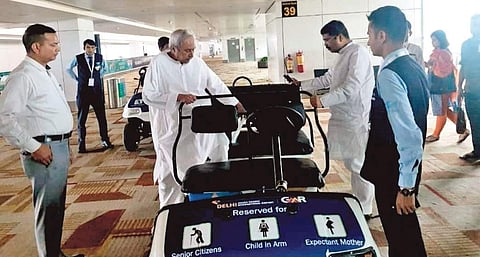 Union Minister Dharmendra Pradhan helps Chief Minister Naveen Patnaik get onto a vehicle at Delhi airport | Sources