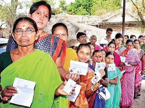 Voters line up outside a polling centre in Karimnagar district on Friday | Express