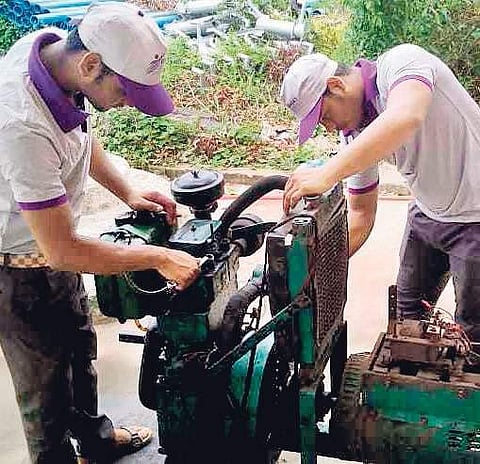 Mechanics busy repairing defunct generators