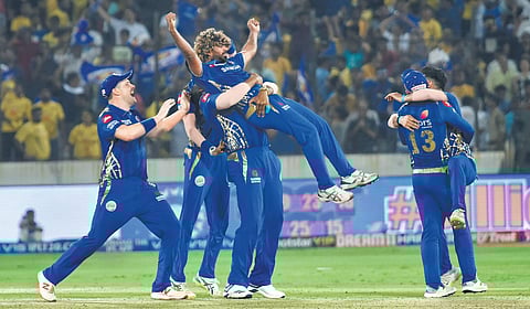 Mumbai Indians players celebrate after winning the final against Chennai Super Kings on Sunday. Chennai’s Shane Watson (right) hit a 59-ball 80 in vain | vinay MADAPU