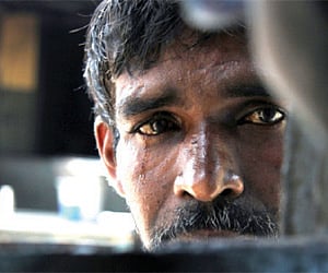A file photo of Vijayakumar speaking to ‘Express’ through the window on the door of the rehabilitation centre for beggars in the city.(Photo | EPS)