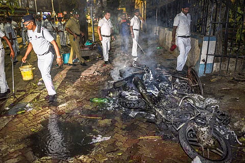 Police personnel douse burning vehicles caused by a mob during BJP President Amit Shah's election roadshow for the last phase of Lok Sabha polls in Kolkata Tuesday May 14 2019. | PTI