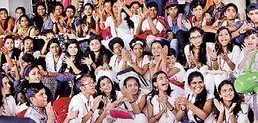 Children clap to a song performed by Jassie Gift, a music composer and playback singer who arrived for the 'Meet the Artist' session held as part of ICFFK at Kairali theatre Vincent Pulickal