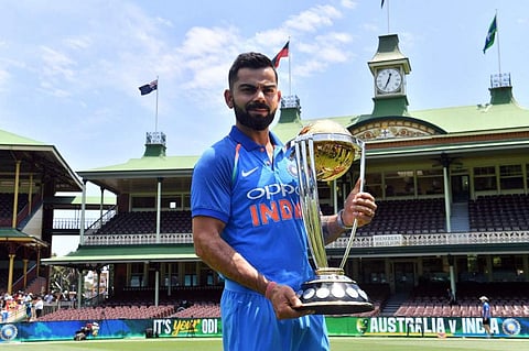 Virat Kohli poses with the ICC Cricket World Cup trophy. (Photo | AFP)