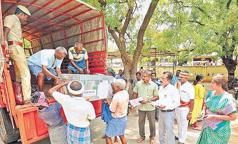 Electronic voting machines and other polling materials being loaded onto vehicles at the Aravakurichi taluk office on Saturday | Express