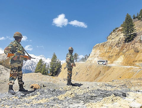 Soldiers stand guard as vehicles pass through Zojila Pass on their way to frontier region of Ladakh. Road connectivity is a major poll issue in Ladakh | Pti File