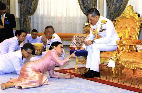 Thailand's King Maha Vajiralongkorn Bodindradebayavarangkun presents a gift to Queen Suthida Vajiralongkorn Na Ayudhya at Ampornsan Throne Hall in Bangkok (Picture | AP)