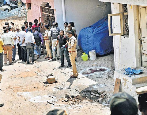 FSL team, bomb squad and police personnel inspect the the MLA’s parking lot in Vyalikaval where a blast took place on Sunday