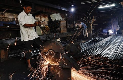 Workers make pipes used for drilling, at a factory in an industrial area in Mumbai. (File | Reuters)