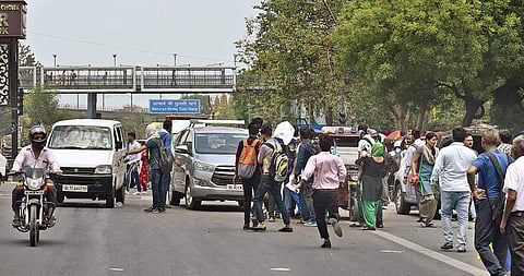 Commuters make a beeline for private taxis and buses outside  the Chhatarpur station | pARVEEN NEGI