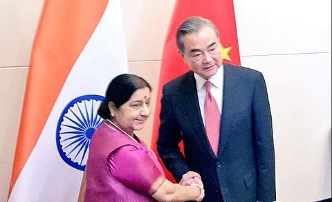 External Affairs Minister Sushma Swaraj shakes hands with her Chinese counterpart Wang Yi (Photo| Twitter/ Raveesh Kumar)