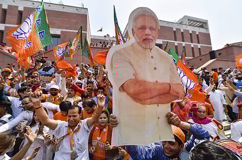 BJP supporters carry a cut-out of PM Narendra Modi as they celebrate the party's victory in the 2019 Lok Sabha elections in New Delhi. (Photo | PTI)