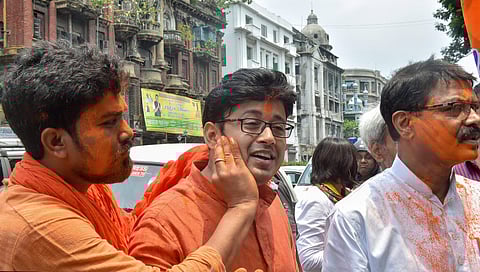 BJP supporters show victory sign as they celecbrate their party's lead in the Lok Sabha elections at BJP office in Kolkata Thursday May 23 2019. | PTI
