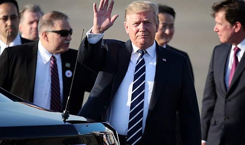 US President Donald Trump waves as he arrives at the Haneda International Airport. (Photo | AP)