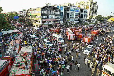 Firefighting trucks seen outside Taxshila Complex after a fire engulfed the third and fourth floor of the complex in Surat (File Photo | PTI)
