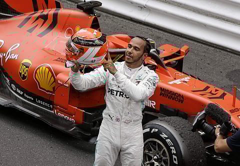 Hamilton lifted his red helmet in tribute to Niki Lauda | AP