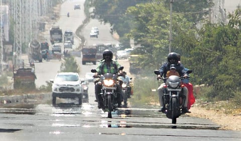 Daily commuters seen on mirage-ridden roads of Sankerpally despite the staggering heat wave prevailing over Hyderabad on 26 May 2019. (Photo | Sathyakeerthi, EPS)