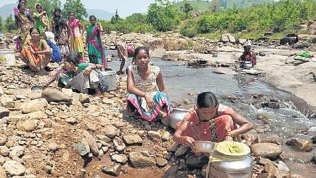 Women collect water from a nullah in Baladia village I Express