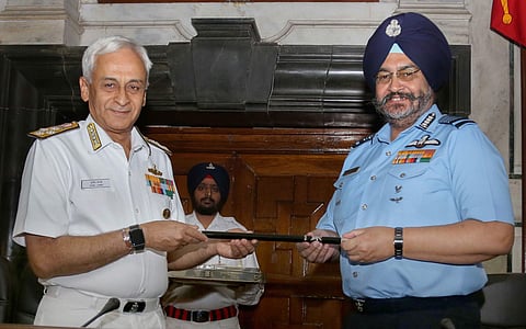 Chief of the Air Staff Air Chief Marshal BS Dhanoa receives the Chairman Chiefs of Staff Committee COSC baton from outgoing Chief of the Naval Staff Admiral Sunil Lanba in a ceremony at South Block in New Delhi Wednesday. (Photo | PTI)