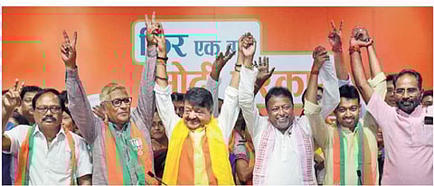 BJP leaders Kailash Vijaivargiya and Mukul Roy join hands with two Trinamool Congress MLAs and one CPM legislator, who defected to the BJP, in New Delhi on Tuesday | PTI
