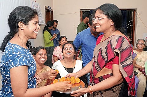 V Muraleedharan’s wife K S Jayasree (right) distributes sweets at their house in Kozhikode on Thursday during the former’s oath-taking ceremony |  T P Sooraj