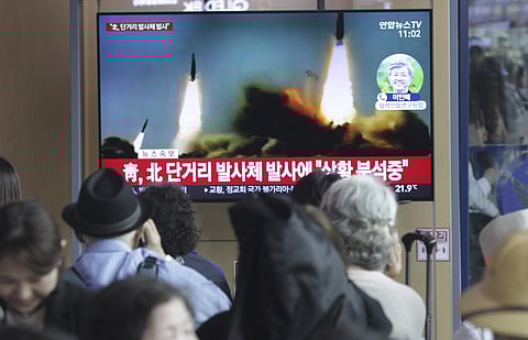 People watch a TV showing a file footage of North Korea's missile launch during a news program at the Seoul Railway Station in Seoul, South Korea (Phorto | AP)