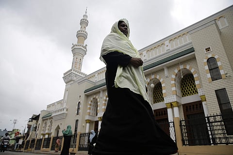 A Sri Lankan muslim woman walks past a mosque in Colombo, Sri Lanka. (Photo | AP)