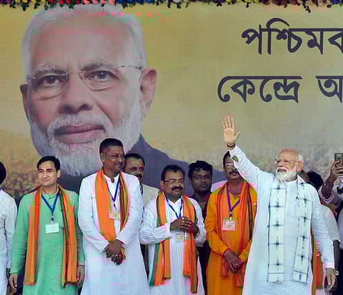 Prime Minister Narendra Modi waves at supporters during an election campaign rally for the Lok Sabha polls at Haldia in East Midnapore district of West Bengal on Monday. (Photo | PTI)