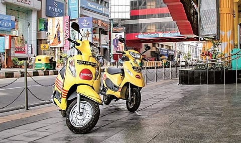 Bounce two-wheelers parked in front of a Metro station