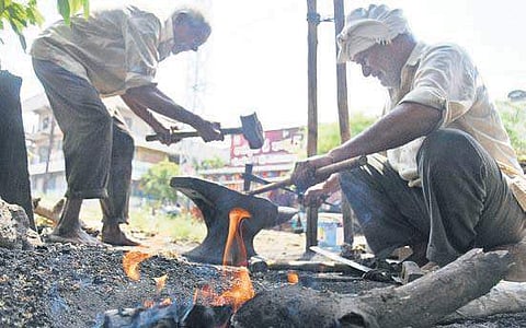 Workers make metalware in heat at a unit in Vijayawada on Monday | P Ravindra Babu