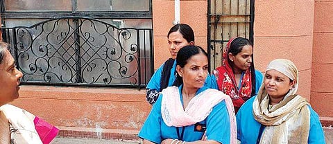 Some of the building staff who were beaten in the apartment building in JP Nagar, Bengaluru, on Monday; (inset) Narashima Murthy, one of the injured | Express