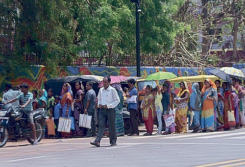 A serpentine queue of beneficiaries to collect relief materials at Capital High School in Bhubaneswar on Tuesday | express