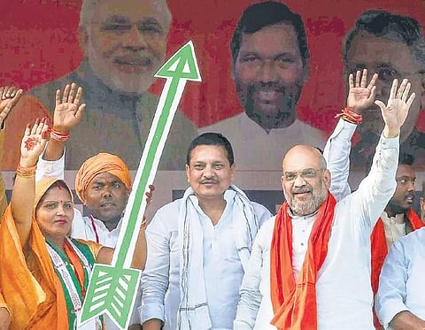 BJP chief Amit Shah with party candidate Kavita Singh (L) at a rally in Siwan | PTI