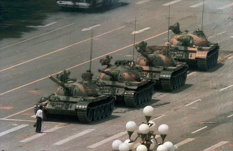 In this June 5, 1989, file photo, a Chinese man stands alone to block a line of tanks heading east on Beijing's Changan Blvd. in Tiananmen Square on Jeff Widener who created the iconic image of tank man says its time for China's government to 'come clean'