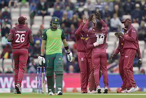 West Indies' Sheldon Cottrell celebrates taking the wicket of South Africa's Aiden Markram during the World Cup cricket match between South Africa and the West Indies. (Photo | AP)